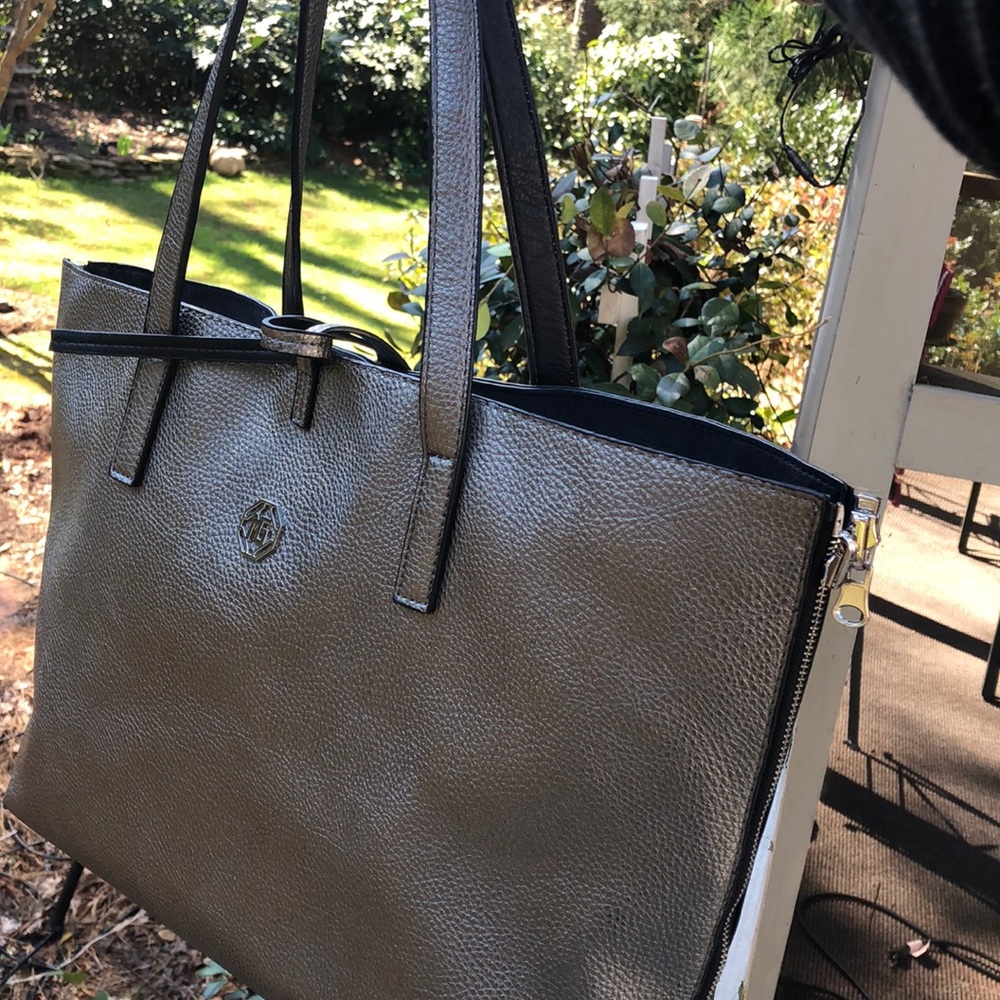 Pewter colored handbag  stylish zipper around bag.